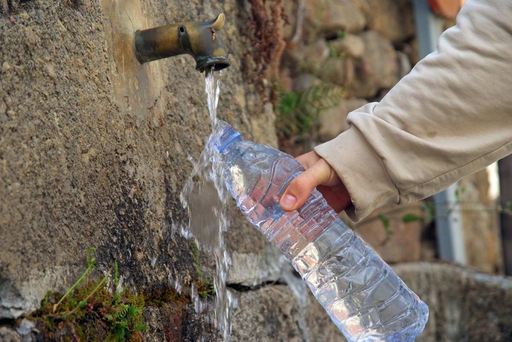 Filling a water bottle to stay hydrated